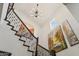 Elegant staircase features dark wood railings, white walls, and artwork creating a sophisticated architectural detail at 15711 S 11Th Ave, Phoenix, AZ 85045