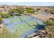 Aerial view of community tennis courts with well-maintained surfaces and surrounding landscaping at 15711 S 11Th Ave, Phoenix, AZ 85045
