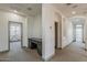 Upstairs hallway featuring a built-in desk and multiple doorways, offering a view from one end to a patio at 15711 S 11Th Ave, Phoenix, AZ 85045