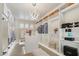 Well-lit walk-in closet with shelves, cabinets, and a decorative light fixture at 15711 S 11Th Ave, Phoenix, AZ 85045