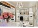 A luxe walk-in closet offers custom shelving, cabinets, and an island with a glass display table at 15711 S 11Th Ave, Phoenix, AZ 85045