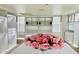 Spacious walk-in closet with custom shelving, drawers, glass-front cabinets, and a white center island at 15711 S 11Th Ave, Phoenix, AZ 85045