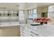 Large, bright walk-in closet with custom storage, drawers, glass-front cabinets, and a white center island at 15711 S 11Th Ave, Phoenix, AZ 85045