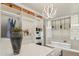 Well-lit walk-in closet offering open shelves, hanging rods, drawers, accent lighting, and a stylish central lighting fixture at 15711 S 11Th Ave, Phoenix, AZ 85045