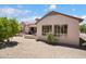Private backyard with a covered patio and desert landscaping, perfect for outdoor living at 16158 W Copper Point Ln, Surprise, AZ 85374