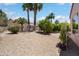 Expansive backyard showcasing decorative gravel, mature trees, and well-maintained landscaping at 16158 W Copper Point Ln, Surprise, AZ 85374