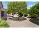 Lush backyard with mature trees and patio area, offering a serene outdoor retreat at 16158 W Copper Point Ln, Surprise, AZ 85374