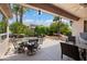 Inviting covered patio with comfortable seating and an outdoor dining area at 16158 W Copper Point Ln, Surprise, AZ 85374