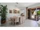 Elegant dining room with a chandelier, access to the patio, and comfortable seating for formal gatherings at 16158 W Copper Point Ln, Surprise, AZ 85374