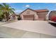 Single-story home with a three-car garage, tile roof, and well-maintained landscaping at 16158 W Copper Point Ln, Surprise, AZ 85374