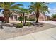 Charming home featuring a well-maintained front yard with desert landscaping and mature palm trees at 16158 W Copper Point Ln, Surprise, AZ 85374