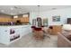 Eat-in kitchen features granite countertops, a breakfast bar, and seamlessly flows into the living area at 16158 W Copper Point Ln, Surprise, AZ 85374