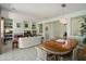 Open-concept living and dining area with tile floors, built-in shelving, and decorative lighting at 16158 W Copper Point Ln, Surprise, AZ 85374