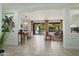 Open-concept living and dining areas with tile floors, neutral decor, and access to the outdoor patio at 16158 W Copper Point Ln, Surprise, AZ 85374