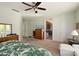 Inviting main bedroom with plush carpet, dresser, and access to a sunroom at 16158 W Copper Point Ln, Surprise, AZ 85374