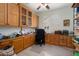 Office features ample built-in cabinetry and workspace, complemented by natural light from a window at 16158 W Copper Point Ln, Surprise, AZ 85374