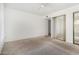 Main bedroom includes neutral walls, carpet flooring, a ceiling fan, and closet space at 1634 E Donner Dr, Tempe, AZ 85282