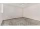 This cozy bedroom features neutral walls, a ceiling fan, and soft gray carpet at 1634 E Donner Dr, Tempe, AZ 85282