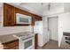 Bright kitchen featuring wood cabinets, granite countertops, and modern appliances at 1634 E Donner Dr, Tempe, AZ 85282