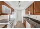 Kitchen features granite counters, white appliances, and wood cabinets for a charming feel at 1634 E Donner Dr, Tempe, AZ 85282