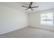 Bright bedroom featuring a ceiling fan, window with blinds, and neutral-toned carpet at 1708 W Estrella Dr, Chandler, AZ 85224