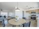 View of dining area featuring a round wooden table and chairs with open floorplan to kitchen and living room at 1708 W Estrella Dr, Chandler, AZ 85224