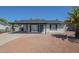 Charming single-story home featuring a carport, desert landscaping, a blue front door, and mature palm tree at 1708 W Estrella Dr, Chandler, AZ 85224