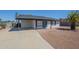 Exterior of home featuring covered parking, desert landscaping, and a front entrance with a blue door at 1708 W Estrella Dr, Chandler, AZ 85224