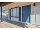 Close-up of front door with blue door and dark trim with view of covered parking at 1708 W Estrella Dr, Chandler, AZ 85224