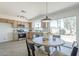 Bright kitchen featuring stainless appliances, stylish cabinets, and a tile backsplash, adjacent to the dining area at 1708 W Estrella Dr, Chandler, AZ 85224