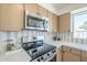 Close up on the stainless steel stove and microwave in this bright kitchen at 1708 W Estrella Dr, Chandler, AZ 85224