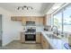 Bright kitchen area with stainless steel appliances, light wood cabinets, and tile backsplash at 1708 W Estrella Dr, Chandler, AZ 85224