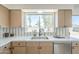 Kitchen sink featuring white countertop, stainless steel sink, and a window to the back yard at 1708 W Estrella Dr, Chandler, AZ 85224