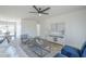 Open-concept living room with neutral tones, dining area, modern furniture, and lots of light at 1708 W Estrella Dr, Chandler, AZ 85224