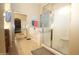 Bathroom featuring a soaking tub, glass shower, and tile flooring at 17516 W Pershing St, Surprise, AZ 85388