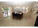 Cozy dining area with a marble-top table, chandelier, and access to outdoor patio through sliding glass doors at 17516 W Pershing St, Surprise, AZ 85388