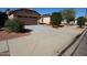 Inviting home exterior featuring a tidy lawn, desert landscaping, and a private driveway at 17516 W Pershing St, Surprise, AZ 85388
