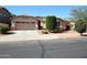 Charming single-story home with a well-manicured front yard, desert landscaping, and a two-car garage at 17516 W Pershing St, Surprise, AZ 85388