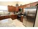 Well-equipped kitchen with stainless steel appliances, granite countertops, and abundant cabinet space at 17516 W Pershing St, Surprise, AZ 85388