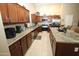 Spacious kitchen featuring dark wood cabinetry, stainless steel appliances, and a central island with seating at 17516 W Pershing St, Surprise, AZ 85388
