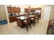 Large kitchen with barstool seating, dark wood cabinetry, stainless steel appliances, and an island at 17516 W Pershing St, Surprise, AZ 85388
