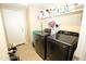 Laundry room with modern washer and dryer, plus storage shelves at 17516 W Pershing St, Surprise, AZ 85388
