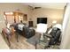Relaxing living room with vaulted ceilings, a ceiling fan, dark reclining furniture and wood-look flooring at 17516 W Pershing St, Surprise, AZ 85388