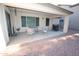 Covered patio with stylish wicker furniture creating a relaxing outdoor living space at 17516 W Pershing St, Surprise, AZ 85388