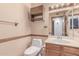 Small bathroom featuring wood cabinetry, and wallpaper at 18814 N 33Rd Ave, Phoenix, AZ 85027