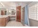 Bathroom features wood cabinets, bathtub, and large mirror at 18814 N 33Rd Ave, Phoenix, AZ 85027