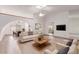 Open concept living room featuring vaulted ceiling, skylight, and views to dining area at 18814 N 33Rd Ave, Phoenix, AZ 85027