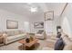 Bright living room with vaulted ceiling, skylight, modern furnishings, and neutral decor at 18814 N 33Rd Ave, Phoenix, AZ 85027