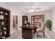 Bright office area with modern desk, ceiling fan, and shelving at 18814 N 33Rd Ave, Phoenix, AZ 85027