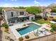 Stunning aerial view of backyard oasis, showcasing the pool, patio, outdoor kitchen, and lush landscaping at 19829 N 97Th St, Scottsdale, AZ 85255